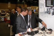 OKOndt Group's expert is showing the foreign colleague the company's portable ultrasonic NDT equipment at the NDT Exhibition South Africa-2012
