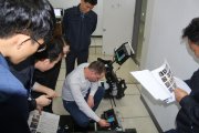 OKOndt Group's specialist teaches employees of the South-Korean company to detect flaws on a rail sample, on-site training, autumn 2018