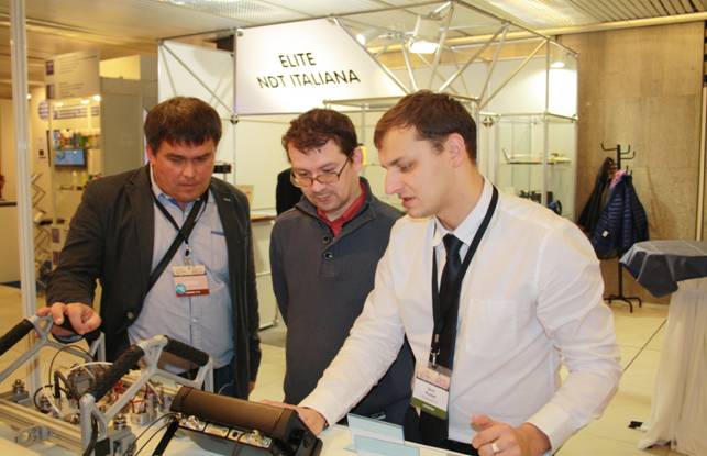 The expert of OKOndt Group is demonstrating ultrasonic NDT equipment to the ECNDT-2014 visitors
