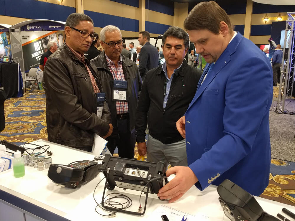 ASNT Annual Conference attendees are approaching to the booth of OKOndt Group to get acquainted with the company's NDT products, Las Vegas, November 2019