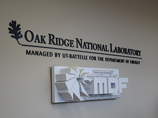 Logos of Oak Ridge National Laboratory and Modern Technologies Factory