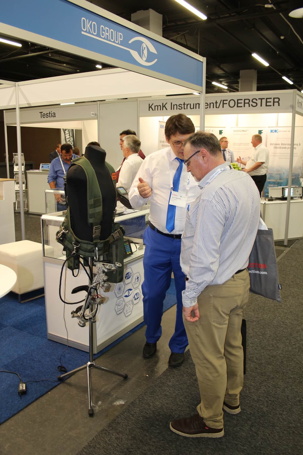 Visitor of the 12th European conference of NDT showing interest to the wireless pipe welds testing system TOFD-Man exhibited at the booth of OKOndt Group