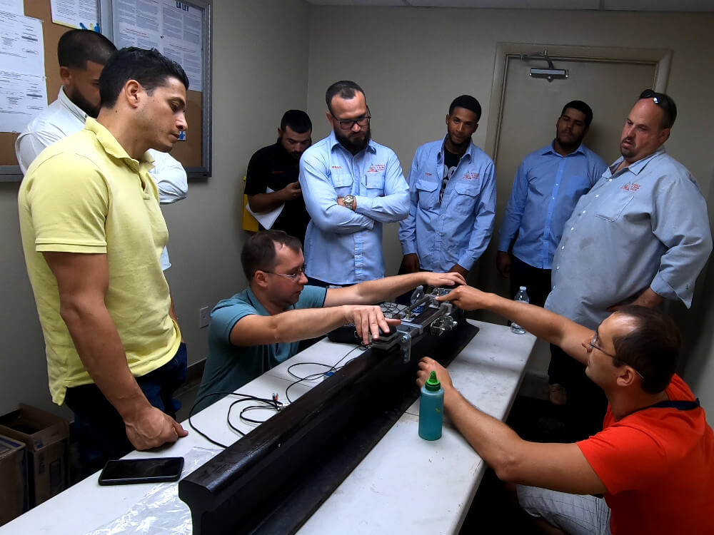 OKOndt Group's specialist is fixing the USR-01 scanner on a rail sample in order to perform the weld testing — on-site training for the American partners, Miami, September 2019