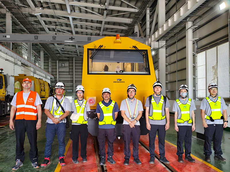 OKOndt GROUP representative and project partners following successful commissioning of the ultrasonic railway inspection system on a Geismar diagnostic vehicle.
